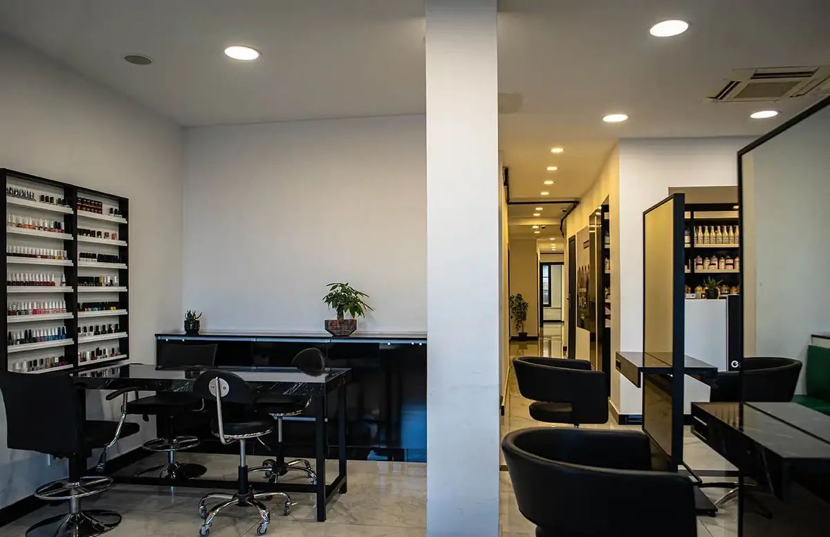 Extension hair samples arranged by shade along the salon wall